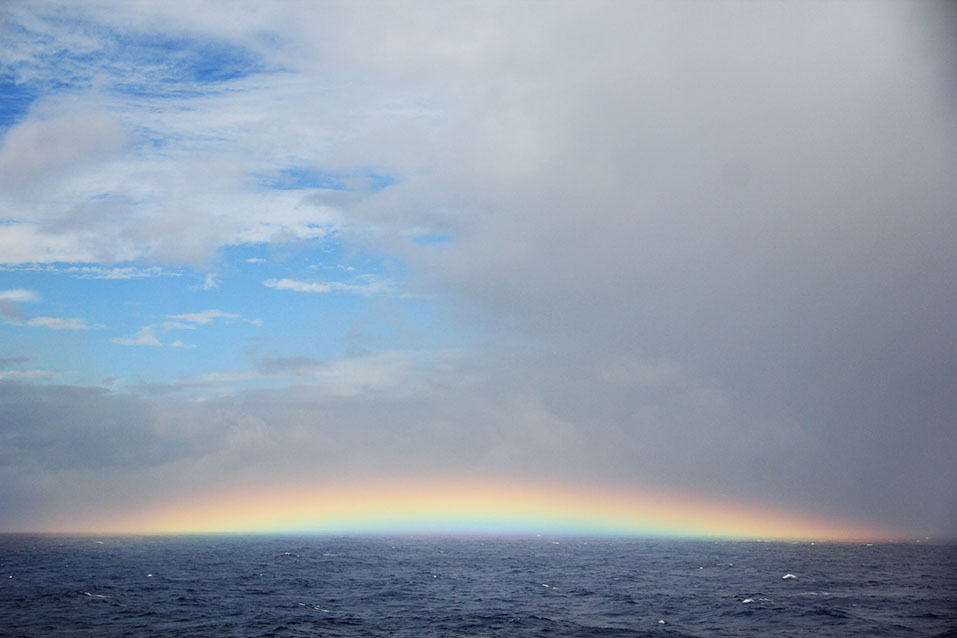 A rainbow appearing in the sky