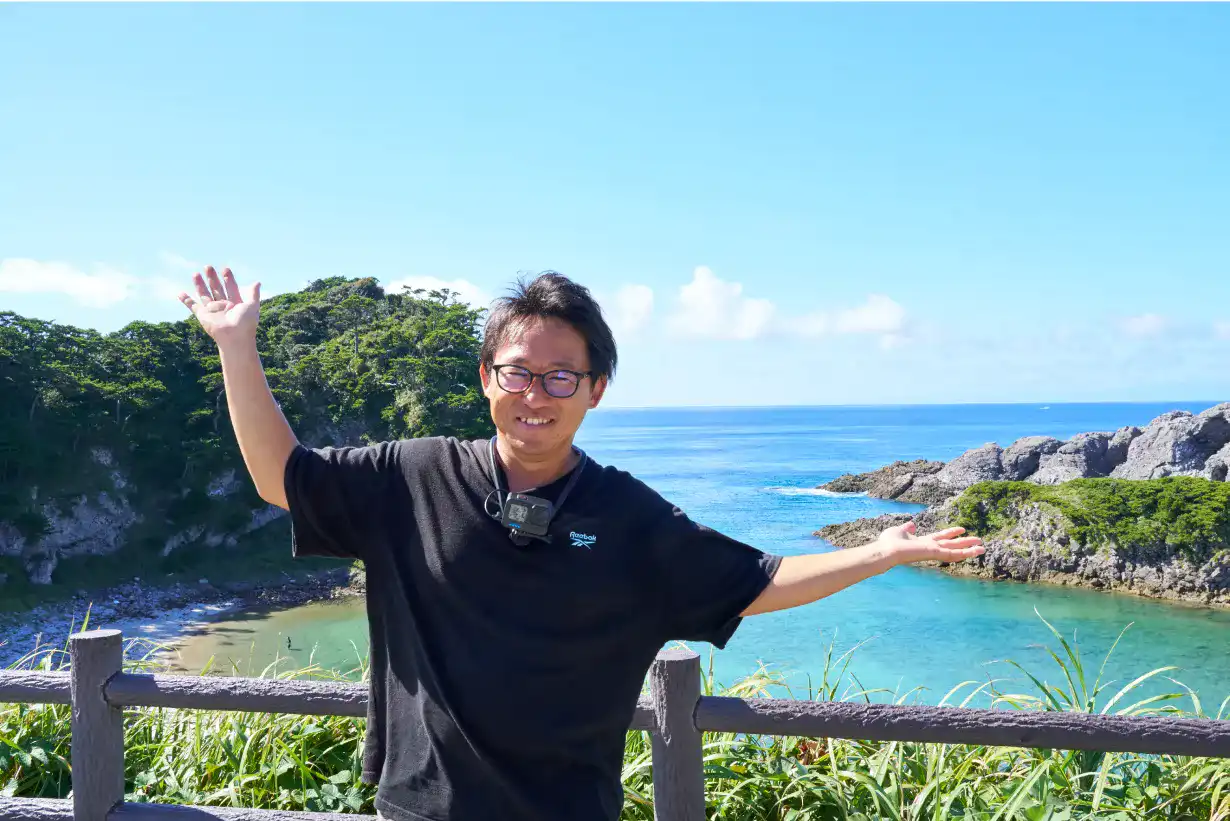 青い空と泊海⽔浴場の青い海を前にポーズを取るとくさん